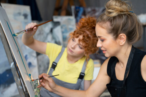 Women Painting With Brushes